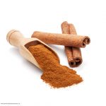 Photo of cinnamon sticks and ground cinnamon in wooden scoop
