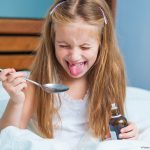 Photo of child making a face after taking medicine