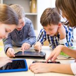 Photo of four children working in group using tablets