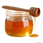 Photo of honey in jar with dipper
