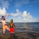 Photo of two children wearing snorkelling gear in water