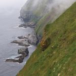 Photo of mist rolling down mountains