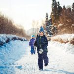 Photo of two children in outdoor winter clothing