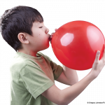 Photo of child blowing up balloon