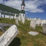Photo of graveyard with leaning tombstones