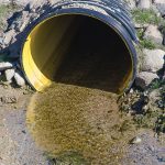 Photo of waste pipe polluting water