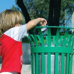 Photo of child putting rubbish in bin