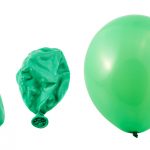 Photo of uninflated, deflated, and inflated green latex balloon