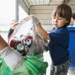 Photo of child recycling cans