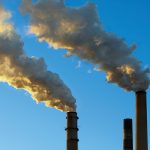 Photo of chimney stacks polluting air